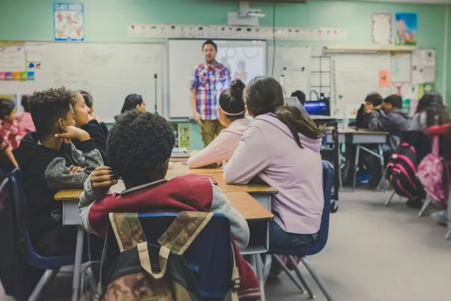 Students in a classroom, representing school physicals